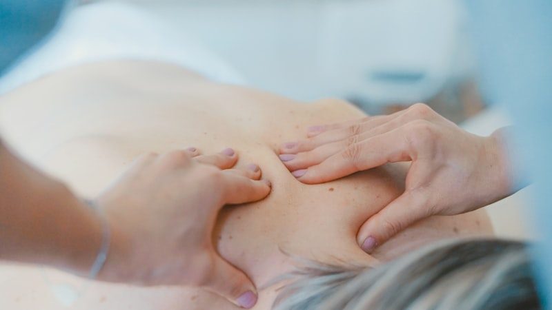 Clinician performing hands-on shoulder therapy